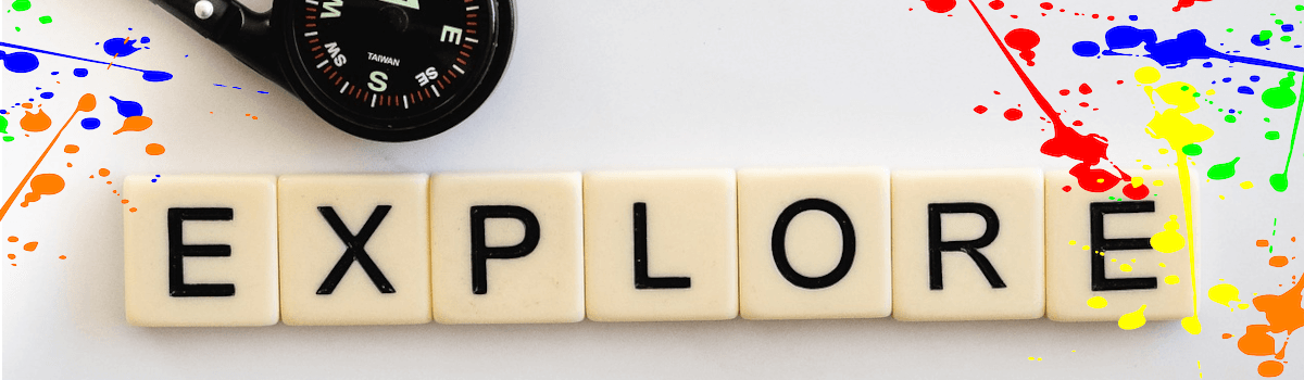 Scrabble tiles spell the word EXPLORE. A black hand compass is to the upper left. Colorful pain splatters are on either side of the tiles.