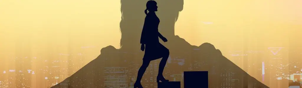 Graphic image of a large shadow of a woman coach. A smaller image of a woman climbing steps upward is seen within the shadown.