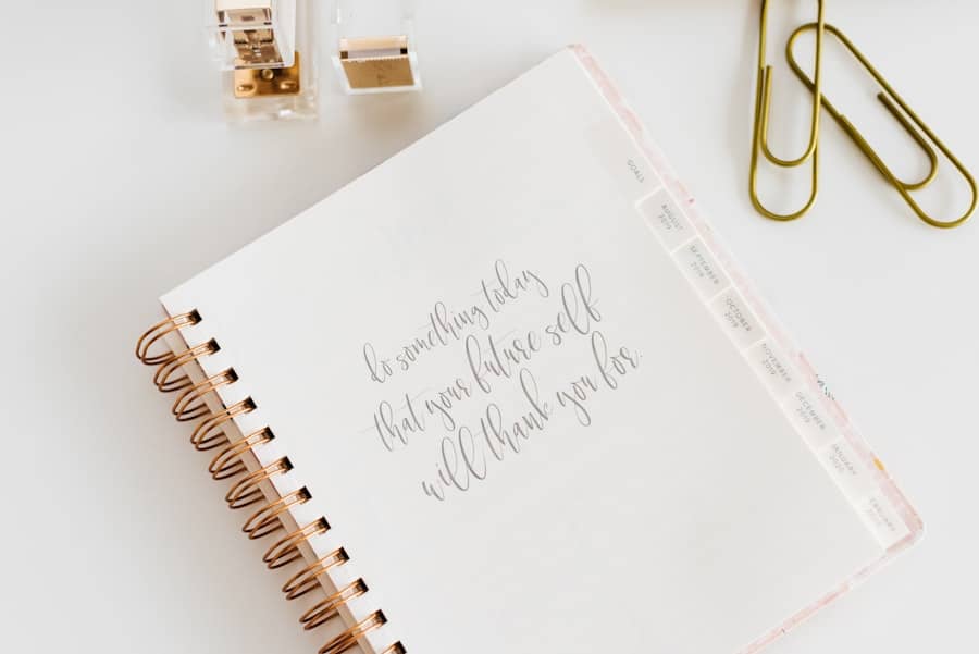 Planner page, paper clips nearby, handwriting on the page.